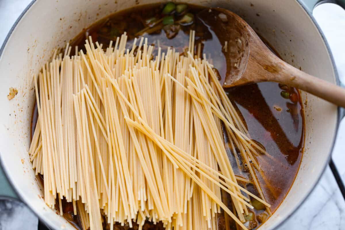Move over spaghetti and meat sauce, dirty spaghetti is here to spice up dinner! Inspired by Cajun dirty rice, it's a one-pot recipe loaded with seasoned beef, tender vegetables, and bold flavors in every bite. Beef broth and dry pasta added to the veggies and ground beef.