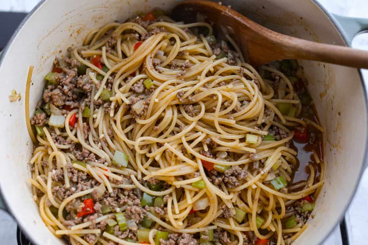 Move over spaghetti and meat sauce, dirty spaghetti is here to spice up dinner! Inspired by Cajun dirty rice, it's a one-pot recipe loaded with seasoned beef, tender vegetables, and bold flavors in every bite. Everything in the dirty spaghetti being stirred together.