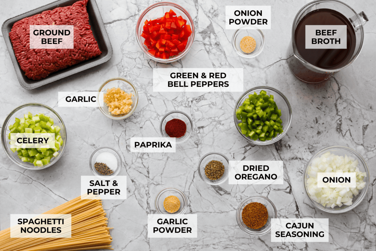 Move over spaghetti and meat sauce, dirty spaghetti is here to spice up dinner! Inspired by Cajun dirty rice, it's a one-pot recipe loaded with seasoned beef, tender vegetables, and bold flavors in every bite. Overhead shot of labeled ingredients.