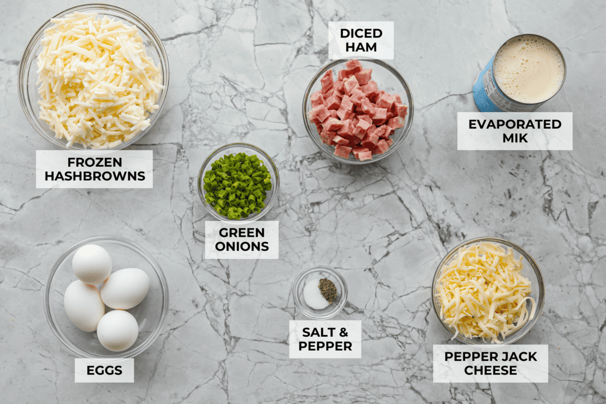 This farmer's casserole is my answer to summer mornings when the kids want cereal again, but I want them to eat something that will actually keep them full. It’s packed with protein, and it's easy to customize with fresh garden veggies. Overhead shot of labeled farmer's casserole ingredients.