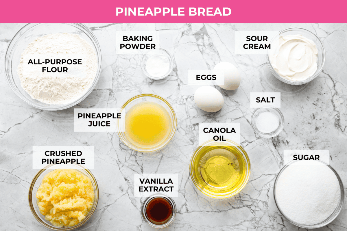 This glazed pineapple bread is what happens when a cozy quick bread meets a tropical vacation. Moist, tender, and drizzled with a sweet pineapple glaze, it's a taste of paradise in every bite. Overhead shot of labeled pineapple bread ingredients.