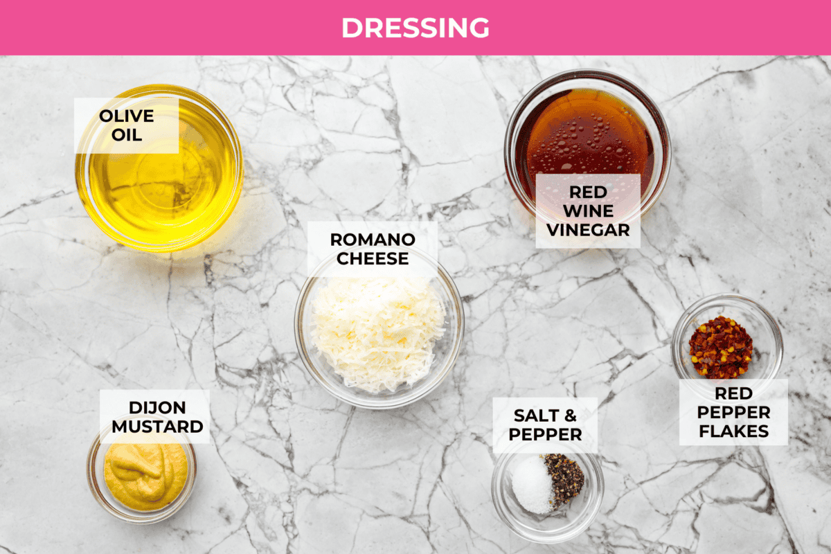 This copycat La Scala Salad is the famous Italian chopped salad from Beverly Hills that Kim Kardashian is rumored to love. It’s fresh, crunchy, and packed with chickpeas, salami, mozzarella, and zesty red wine vinaigrette. Overhead shot of labeled dressing ingredients.