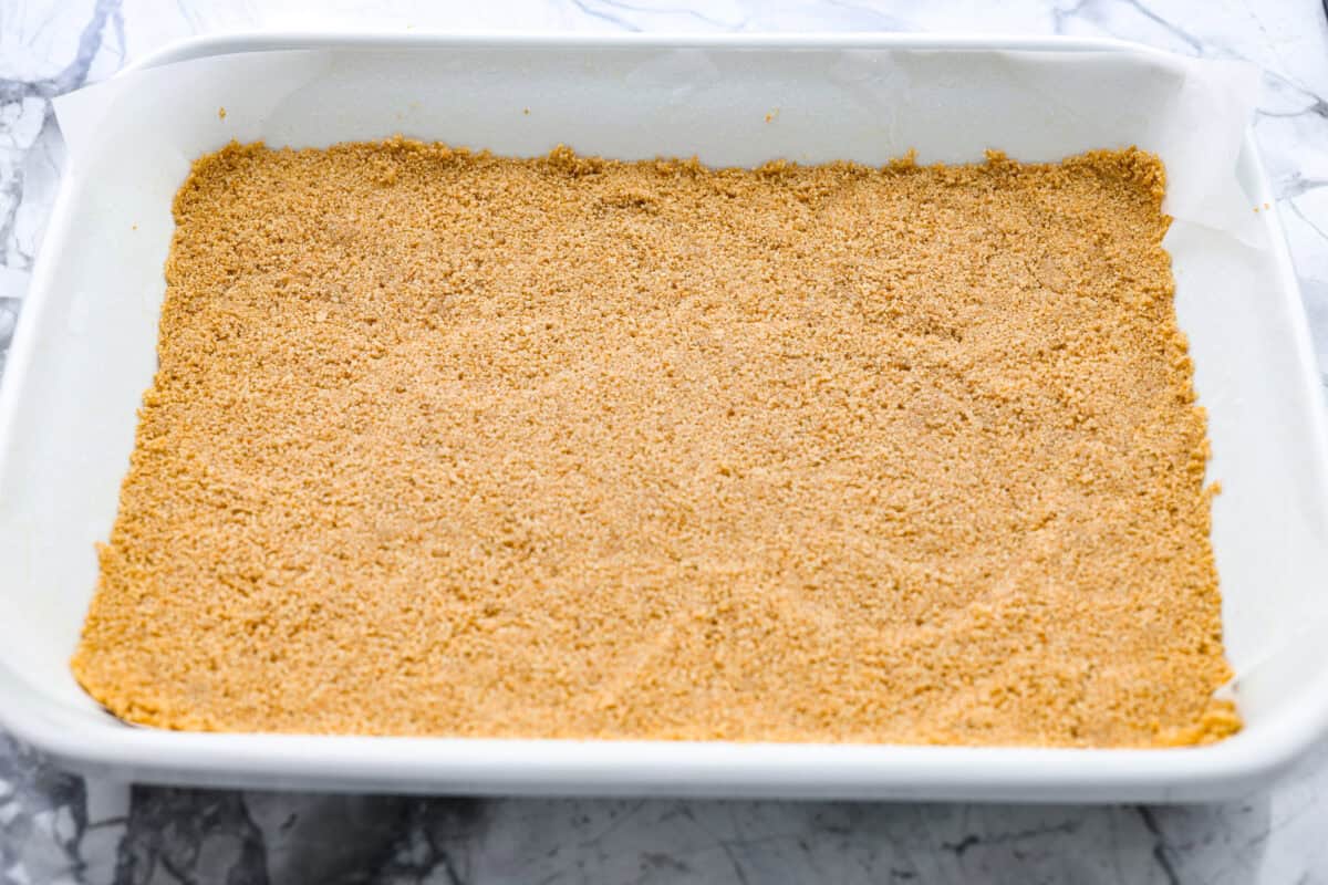 Remember the Starbucks s'mores bars everyone was obsessed with? They're back in homemade form! These easy bars have a buttery graham cracker crust, melty chocolate, and toasted marshmallows for the ultimate no-campfire-required treat. Graham crack crumbs made into a crust and smashed into the bottom of the baking dish.