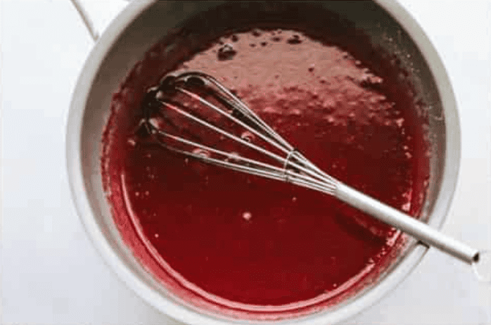 Strawberry Jell-O mixed in with the cornstarch glaze. 