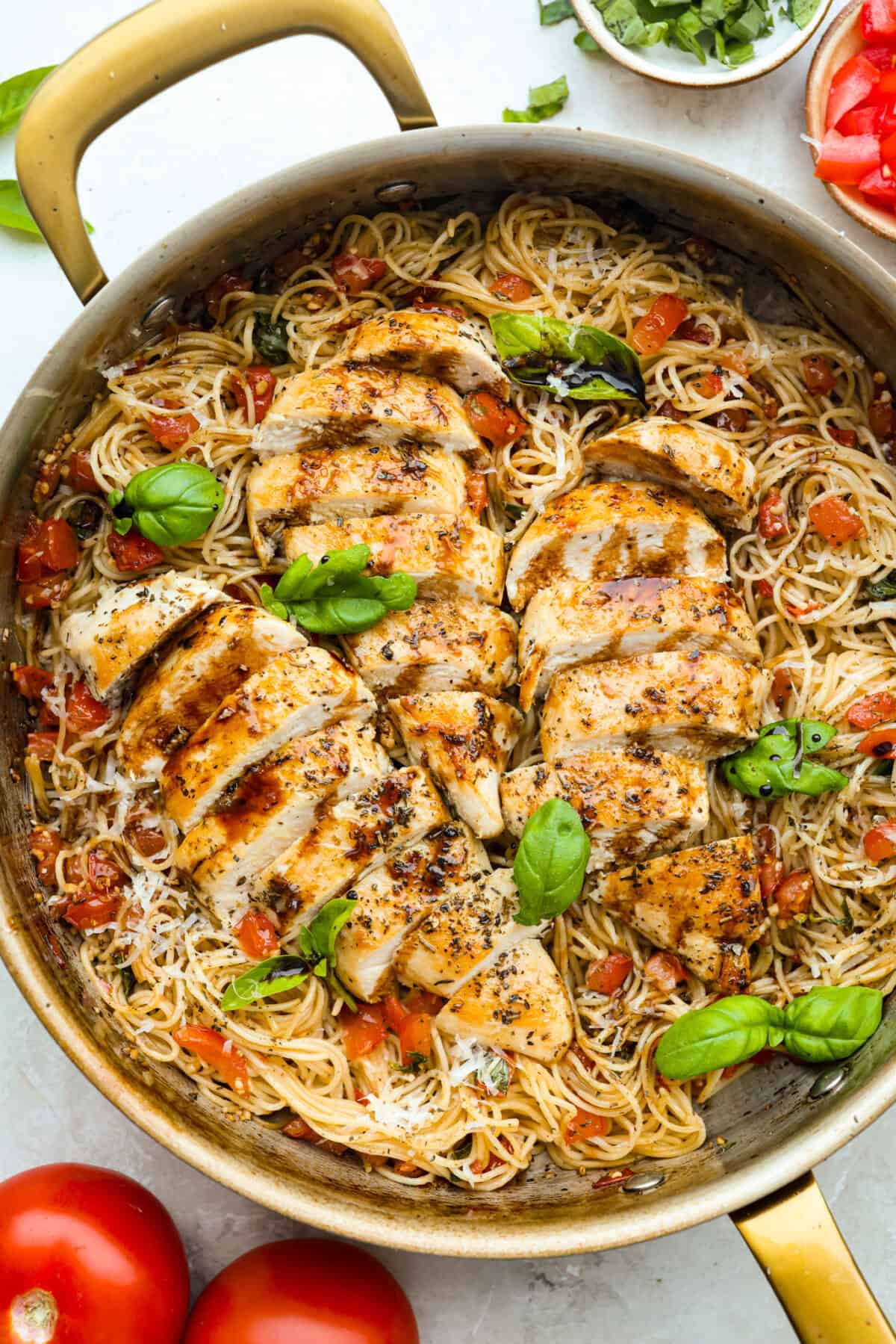 If you have fresh summer tomatoes sitting on your counter, this is your sign to make this Bruschetta Chicken Pasta. It's light, fresh, and shows that simple ingredients can make the best meals. Fresh bruschetta chicken pasta in a skillet.