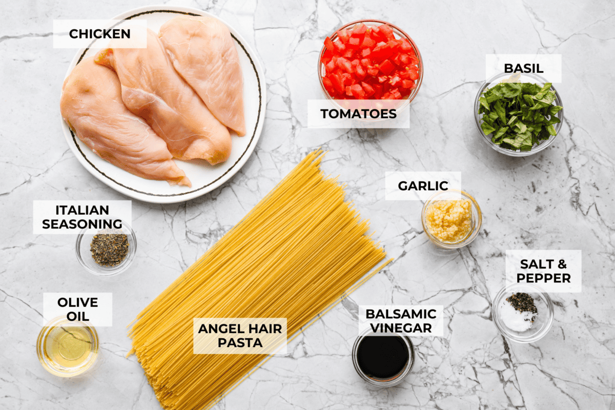 If you have fresh summer tomatoes sitting on your counter, this is your sign to make this Bruschetta Chicken Pasta. It's light, fresh, and shows that simple ingredients can make the best meals. Overhead shot of labeled bruschetta chicken ingredients.