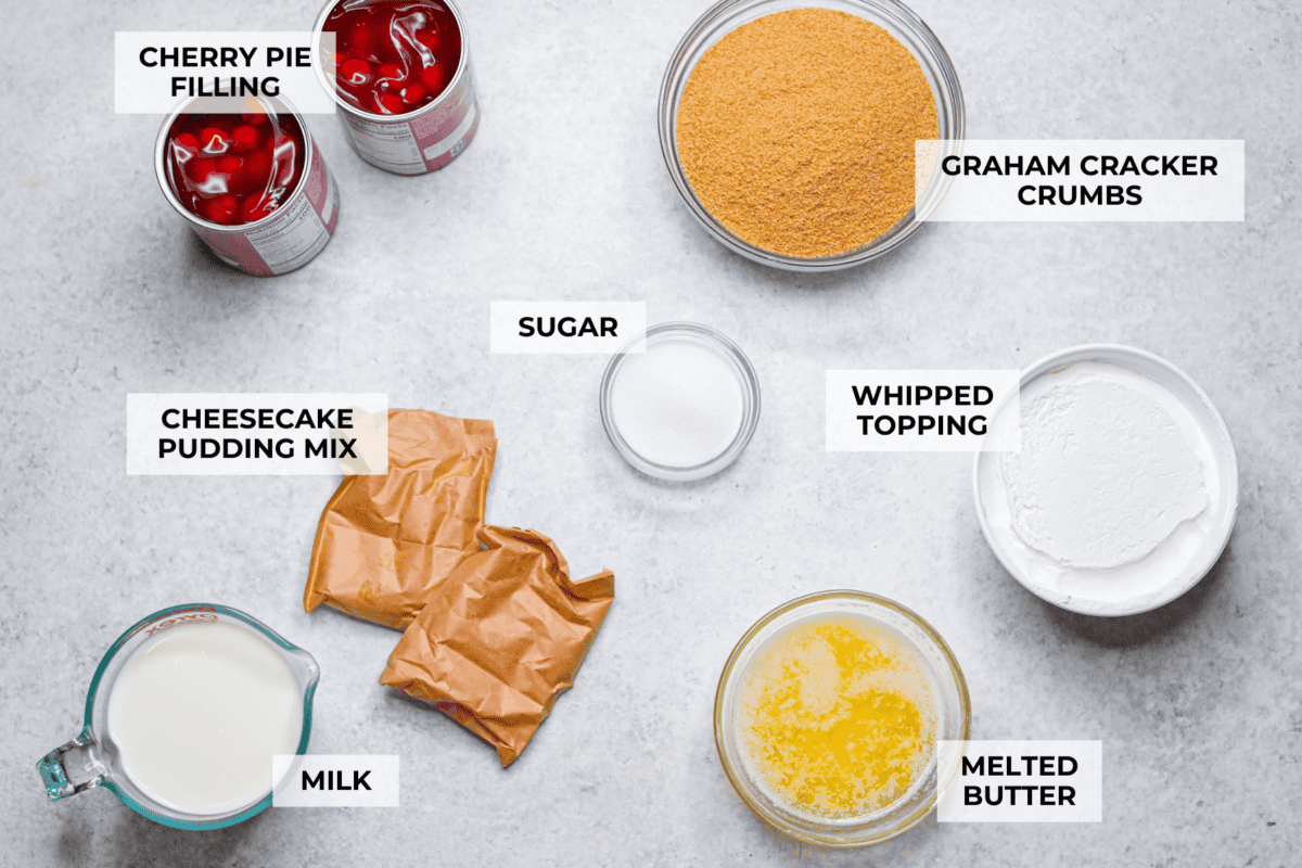 My cherry cheesecake lush is rich, creamy, and incredibly easy to make. With simple layers of graham cracker crust, cheesecake filling, juicy cherries, and whipped topping, it's the perfect no-bake dessert for any occasion. Overhead shot of labeled cherry cheesecake lush ingredients.