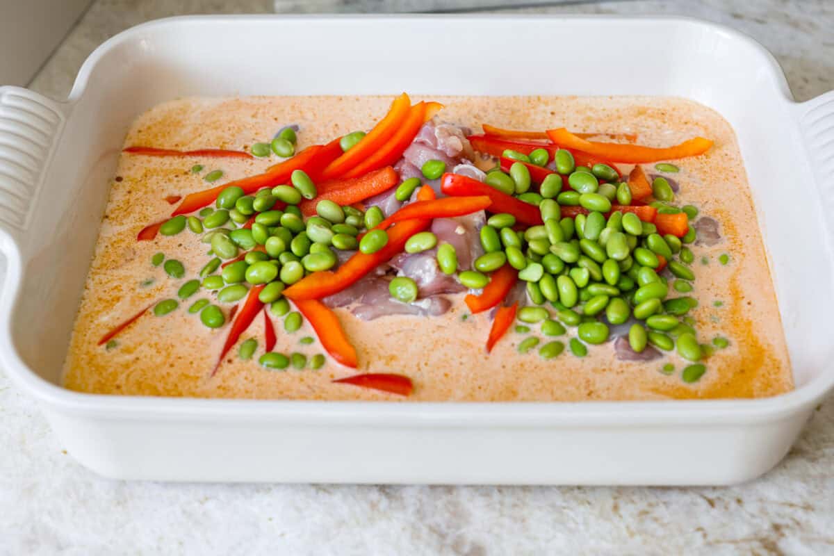 My coconut curry chicken bake proves one pan can do it all! Rice, chicken, and veggies bake in a creamy red curry coconut sauce, soaking up bold Thai flavor. Just 10 minutes of prep, then the oven takes over. Rice, chicken, and veggies added to the coconut curry sauce.