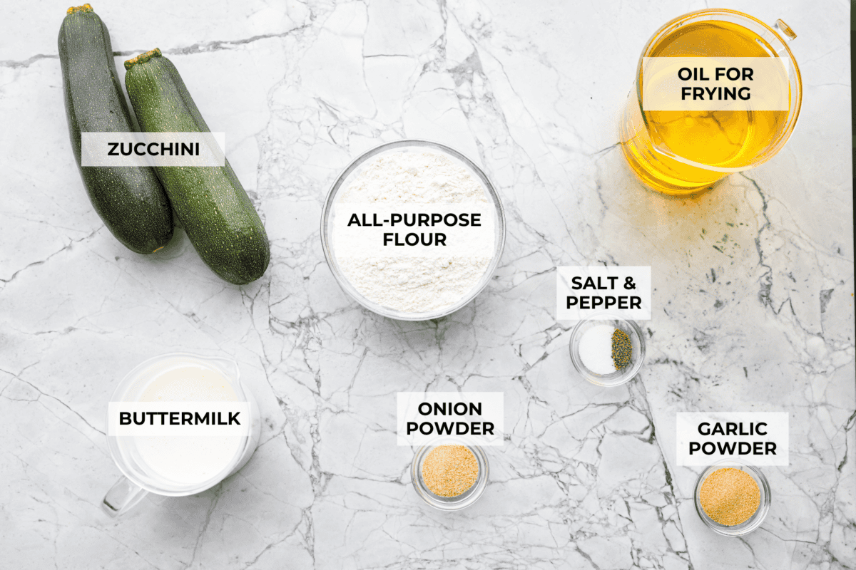 These crispy zucchini strings are golden, crunchy, and seriously hard to stop eating. Lightly battered and fried until perfectly crisp, they turn simple zucchini into an addictive snack or side dish that everyone will reach for first. Overhead shot of labeled ingredients for crispy zucchini strings.