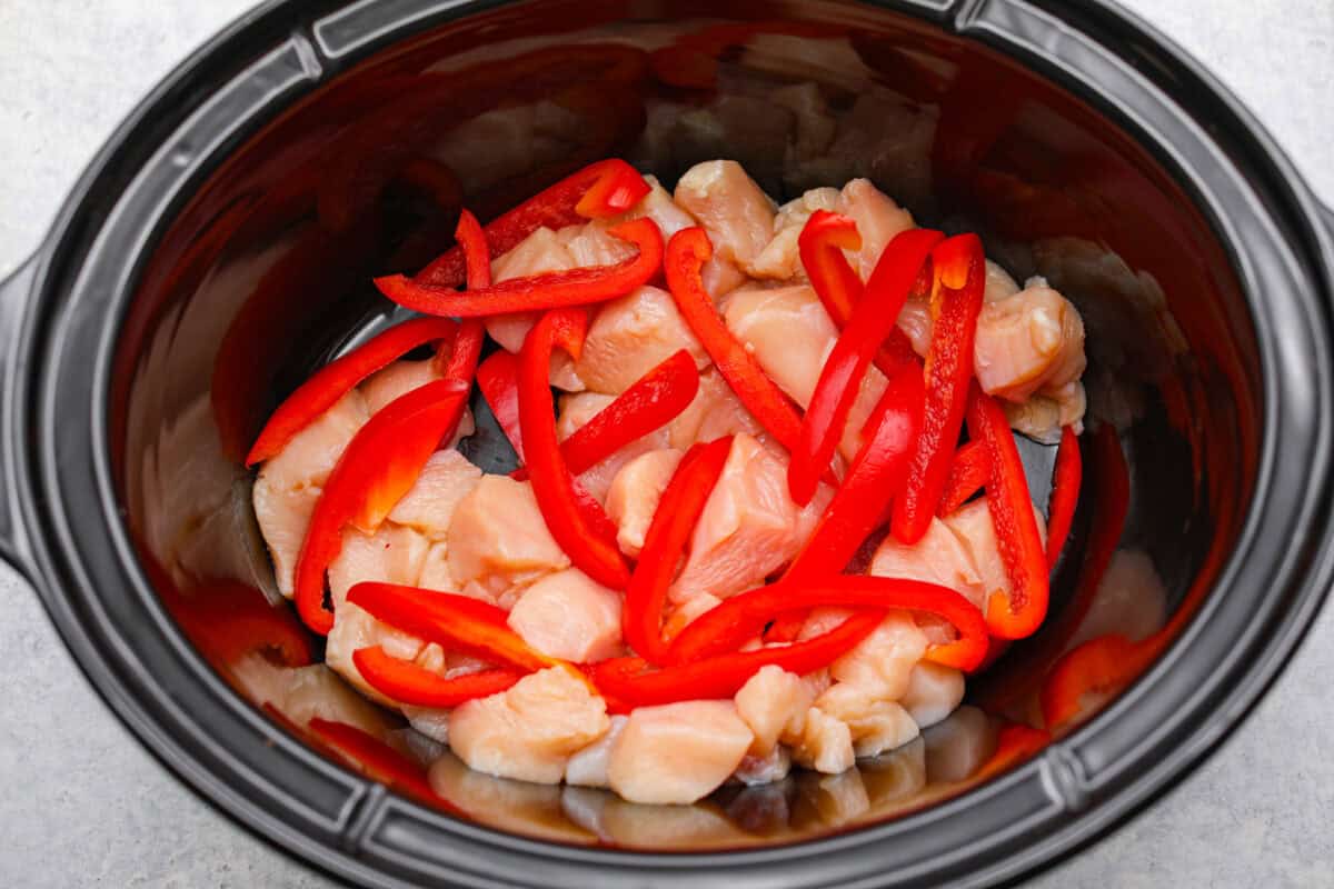 You asked, I listened! This slow cooker Thai peanut chicken got a serious glow-up! The sauce is creamy, savory, a little sweet, and packed with peanut coconut flavor. I’d drink it with a straw if that were socially acceptable, but spooning it over rice, noodles or adding it to lettuce wraps is probably the better dinner move. Chicken and peppers added to the slow cooker.