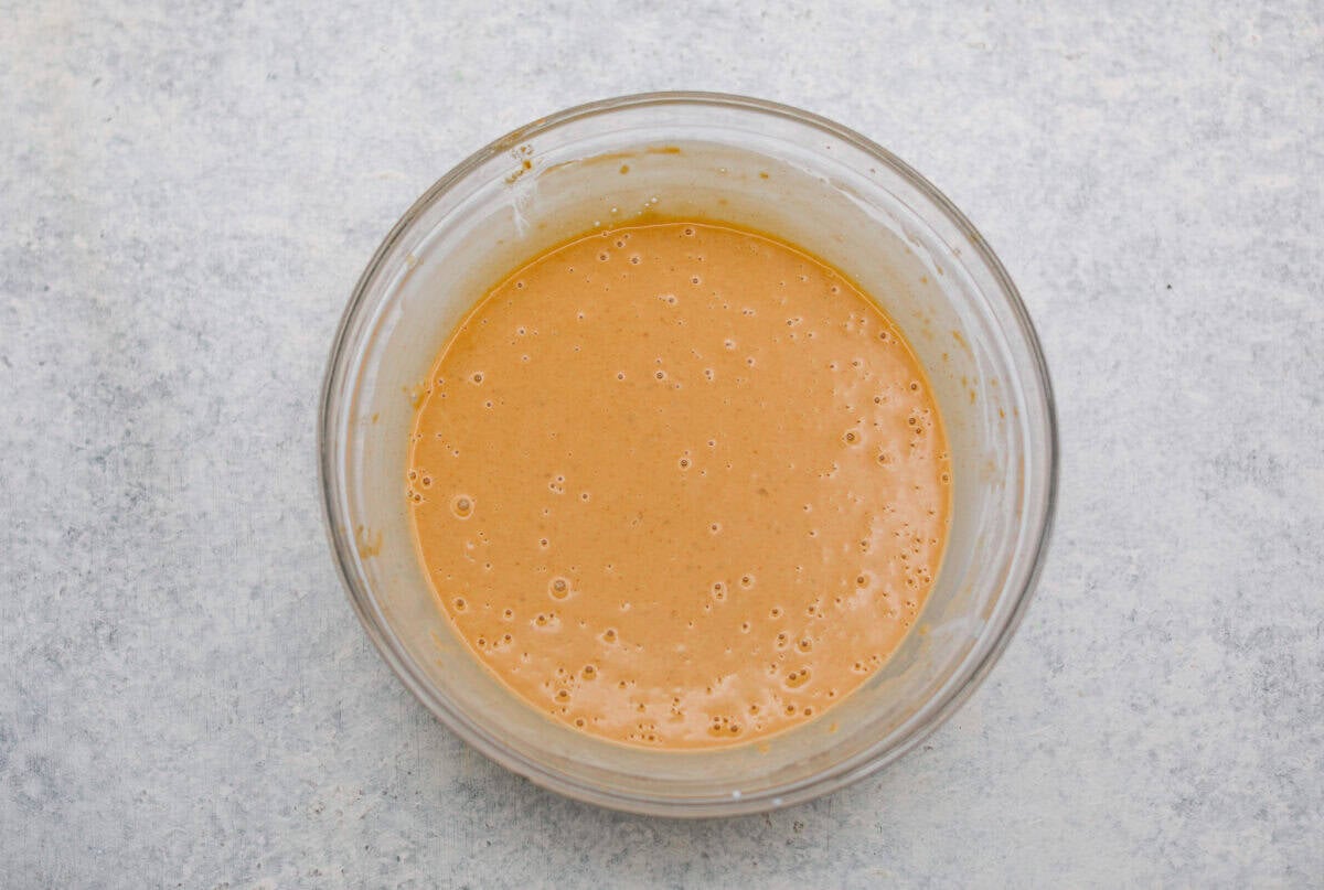 You asked, I listened! This slow cooker Thai peanut chicken got a serious glow-up! The sauce is creamy, savory, a little sweet, and packed with peanut coconut flavor. I’d drink it with a straw if that were socially acceptable, but spooning it over rice, noodles or adding it to lettuce wraps is probably the better dinner move. Sauce ingredients whisked together in a bowl.