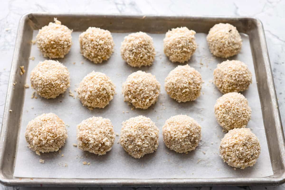 Chicken parmesan meatballs bring all the best parts of chicken parmesan together in one skillet. Think tender chicken meatballs, crispy Parmesan breadcrumbs, saucy marinara, and lots of melted mozzarella. Meatballs formed and coated in the breadcrumb and parmesan mixture.