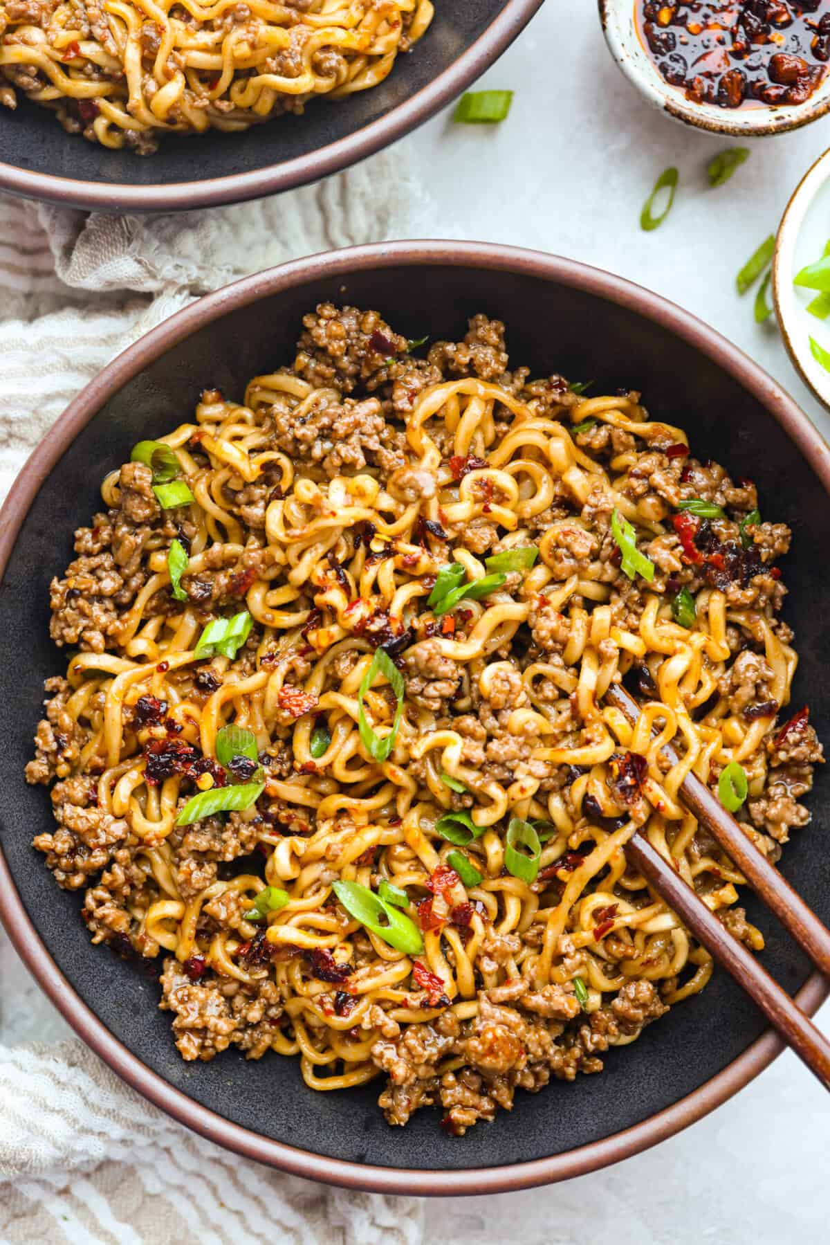 These chili crisp beef ramen noodles are an easy, one-pan dinner you can have on the table in just 20 minutes. Ground beef and ramen noodles cook together in a sweet, savory, and slightly spicy sauce for a quick, filling, and flavorful meal. Bowl of chili crisp beef ramen noodles.