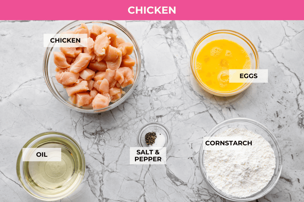 Chinese lemon chicken is lightly fried until golden, then baked in the sticky homemade sauce packed with bright lemon flavor. Make a full take-out-style meal at home with my easy fried rice, cream cheese wontons, and chow mein! Overhead shot of labeled Chinese lemon chicken ingredients.