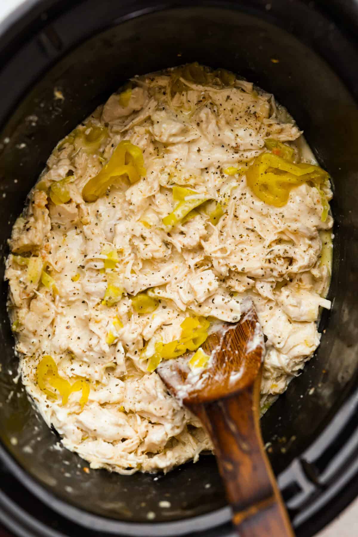 Slow cooker full of crockpot Italian grinder chicken, ready to be eaten. 