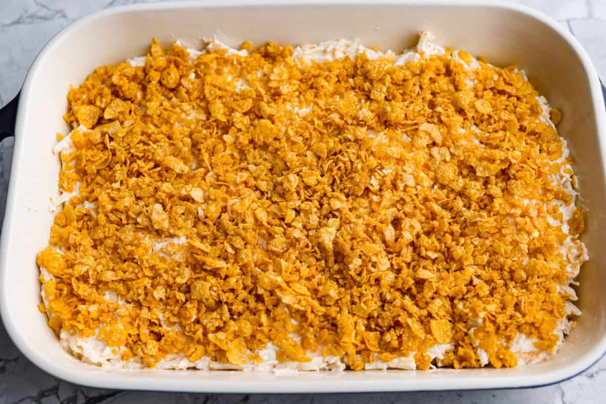 My funeral potato and chicken casserole turns the classic cheesy side dish into a complete dinner. It’s creamy, comforting, and packed with tender chicken, potatoes, and plenty of cheese. Topping sprinkled over the top of the casserole.