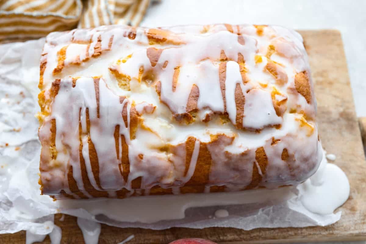 Glaze drizzled over the top of the peach loaf. 