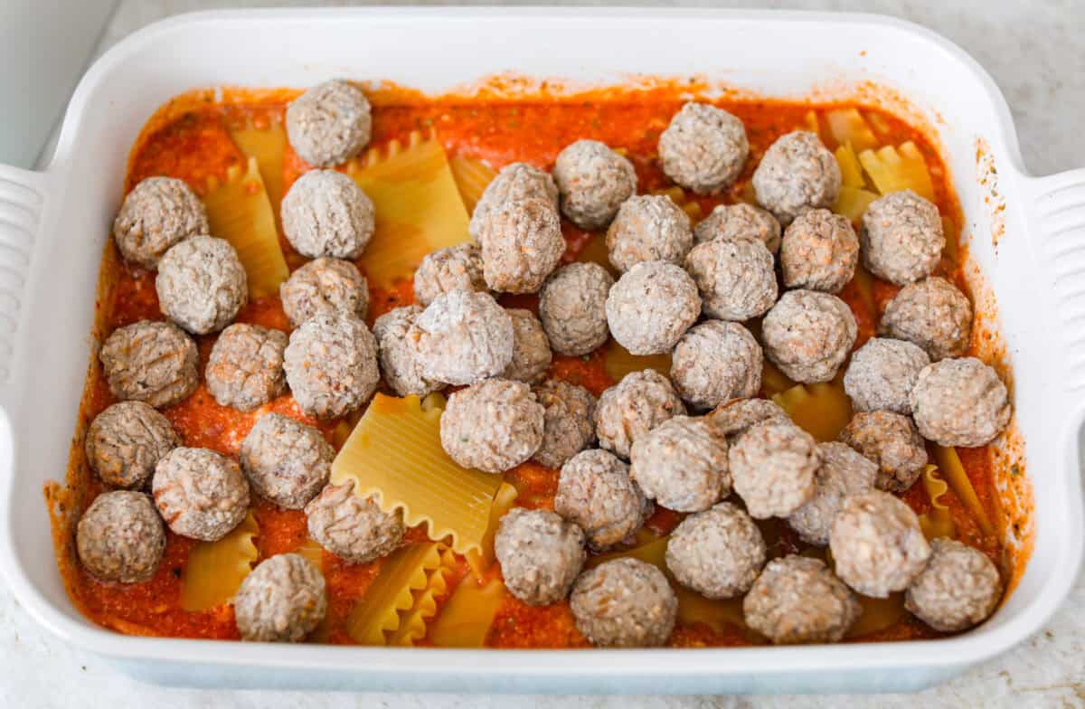 Want lasagna but absolutely cannot deal with all that layering tonight? Let me help you. This lazy meatball lasagna is cheesy, cozy, ridiculously easy, and exactly the kind of dinner we need on a busy night. Meatballs added to the top of the noodle pieces.