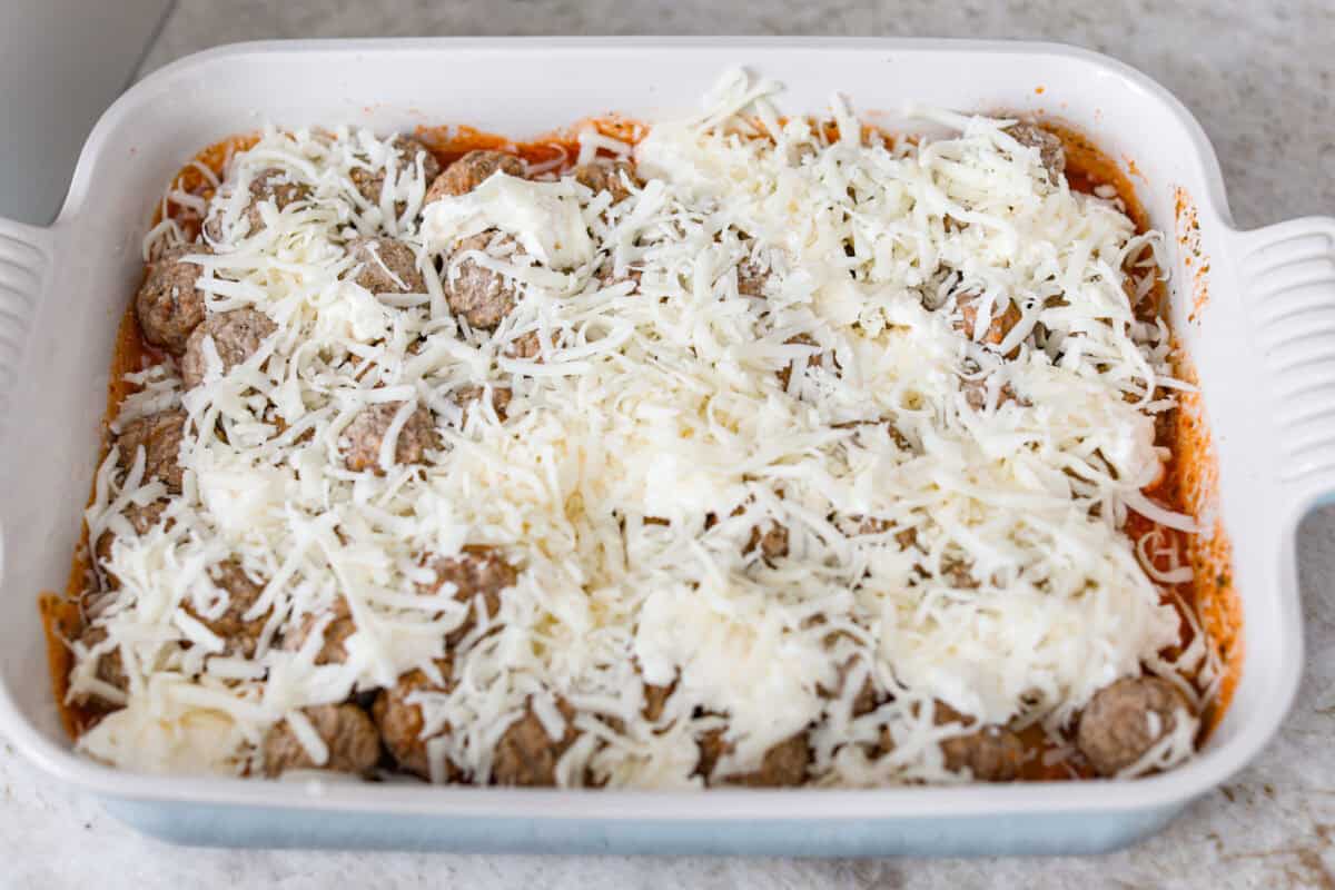 Want lasagna but absolutely cannot deal with all that layering tonight? Let me help you. This lazy meatball lasagna is cheesy, cozy, ridiculously easy, and exactly the kind of dinner we need on a busy night. Cheese added to the top of the meatballs.
