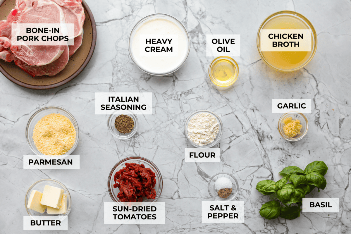 Marry Me pork chops are the kind of dinner that earns its name! Tender pork chops are simmered in a rich, creamy Parmesan sauce with garlic, Italian herbs, and sweet, tangy sun-dried tomatoes. One bite and you’ll get why they’re worth proposing over. Overhead shot of labeled ingredients.