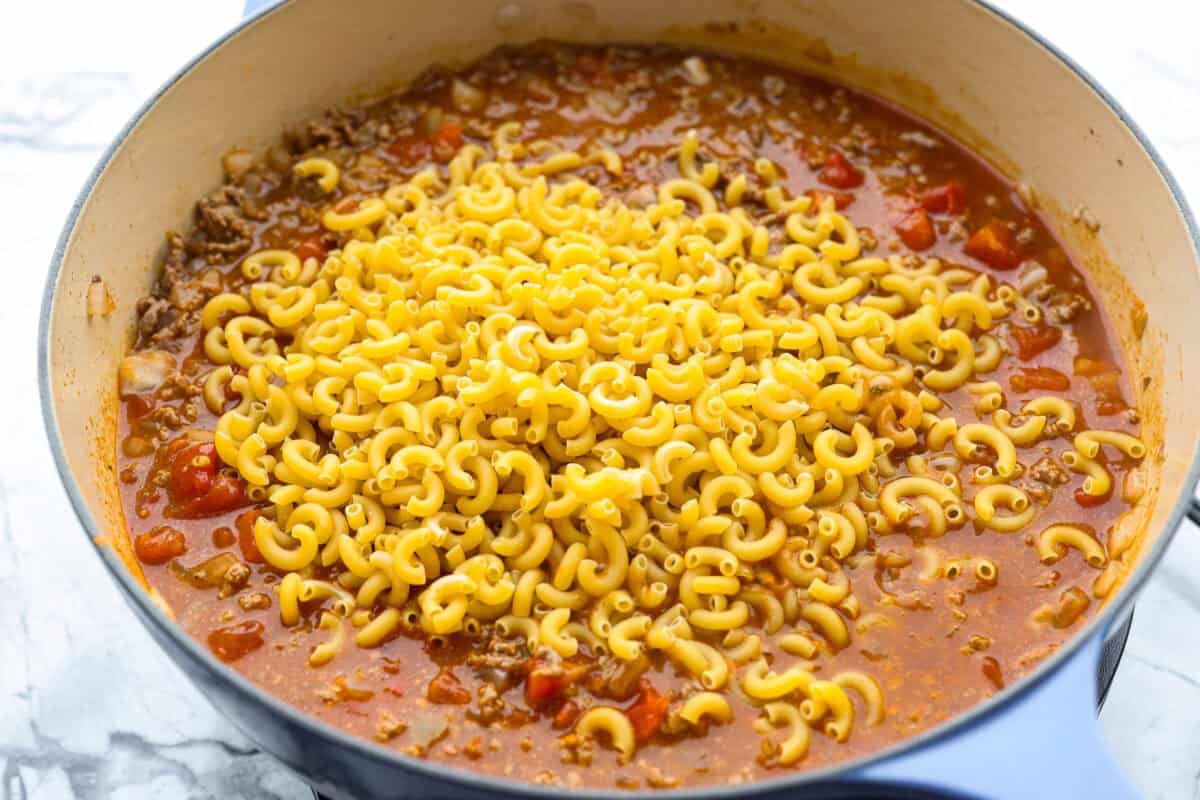 Macaroni noodles added to the skillet.