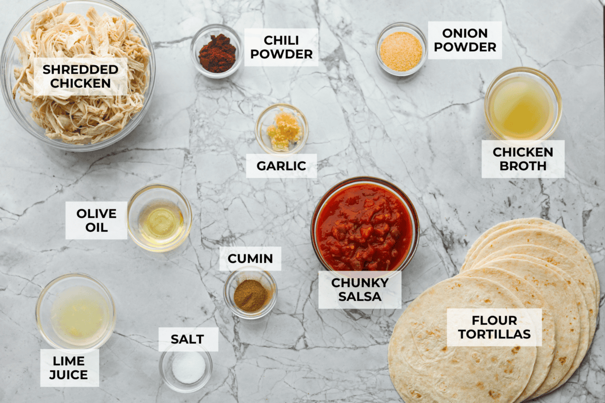 Shredded chicken tacos turn cooked chicken into juicy, flavorful tacos with salsa, lime, and a few simple seasonings. Use rotisserie chicken or choose from four easy ways to cook and shred your own. Overhead shot of labeled shredded chicken tacos ingredients.