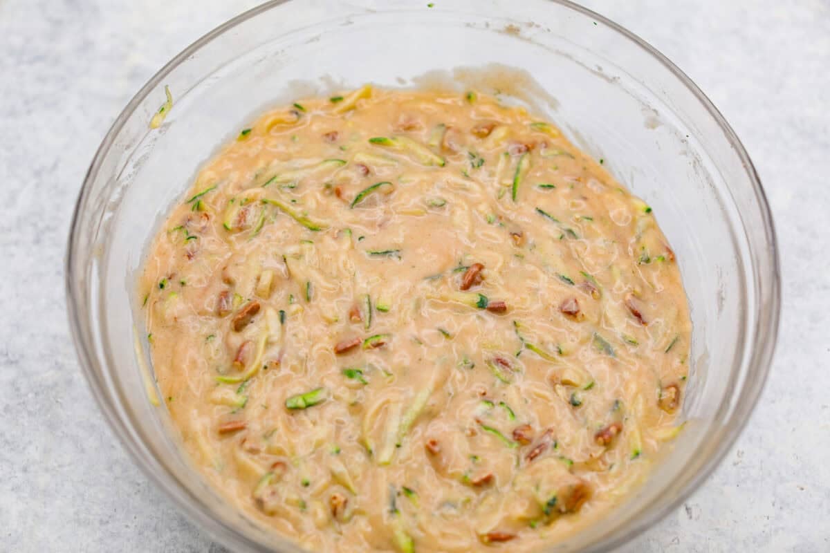 These zucchini bars with brown butter frosting are one of my favorite ways to use up all the zucchini from my garden. The bars are soft, warmly spiced, and incredibly moist, while the nutty brown butter frosting makes every bite taste extra special. Dry and wet ingredients combined with zucchini shreds and pecans mixed in.