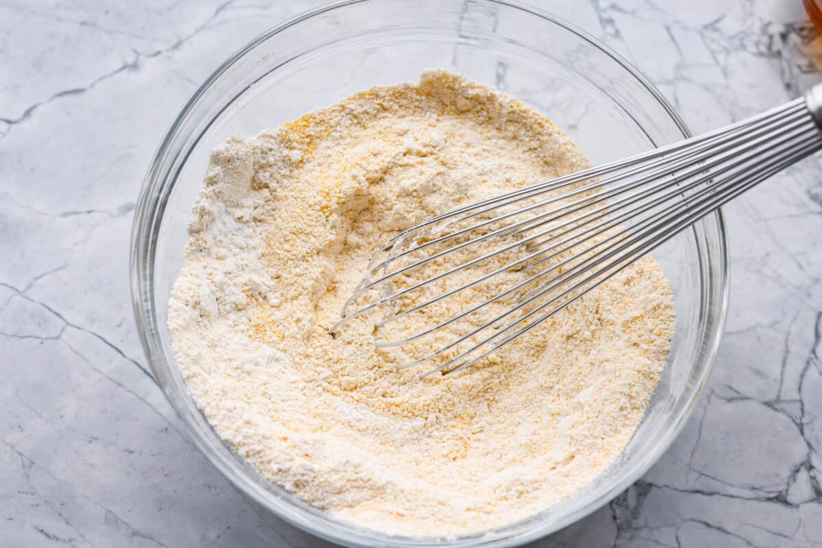 This cornbread loaf is soft, buttery, and just sweet enough, with crisp golden edges and a tender crumb. Baking it in a loaf pan gives classic cornbread a fun twist that’s easy to slice and serve with chili, stew, or your favorite comfort food. Dry ingredients whisked together in a mixing bowl.