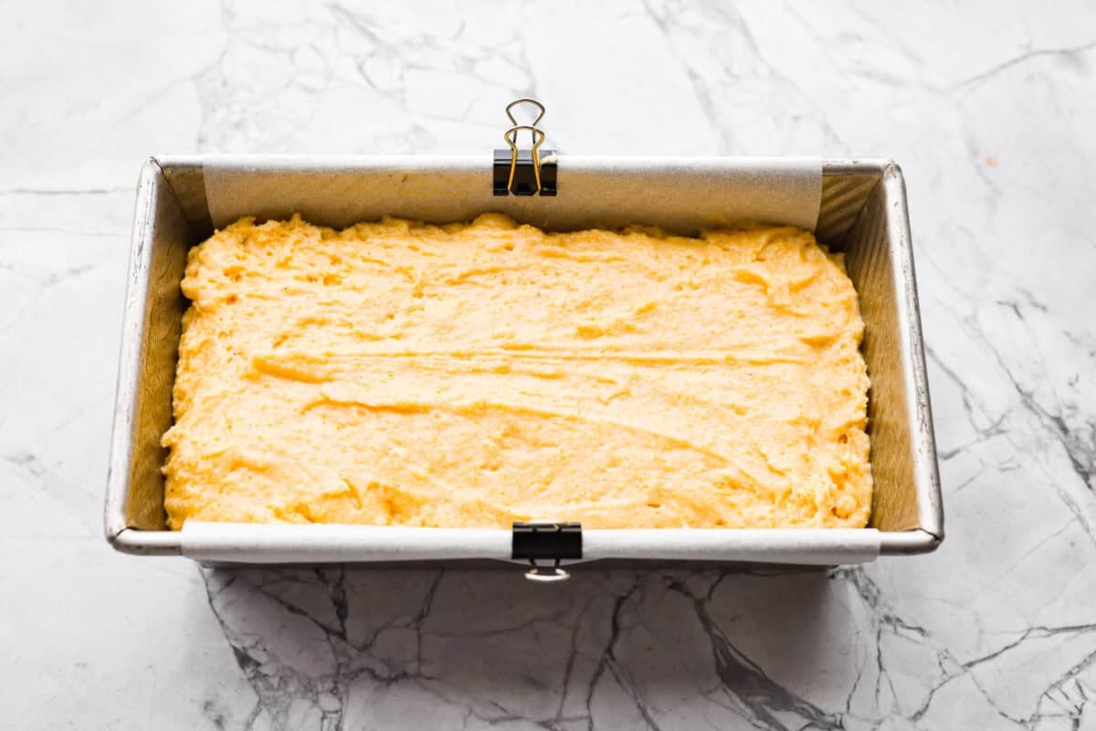 This cornbread loaf is soft, buttery, and just sweet enough, with crisp golden edges and a tender crumb. Baking it in a loaf pan gives classic cornbread a fun twist that’s easy to slice and serve with chili, stew, or your favorite comfort food. Cornbread loaf batter added to the loaf pan.