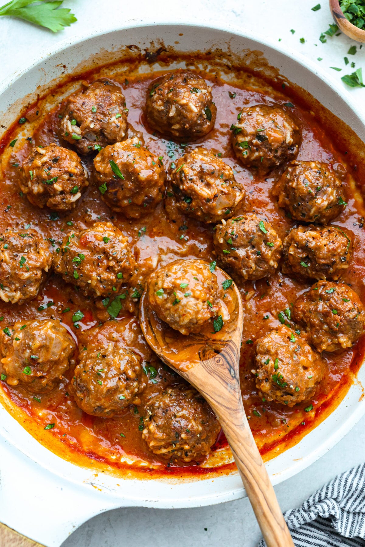 Porcupine Meatballs are juicy, well-seasoned meatballs with tender rice simmered in a rich, tangy tomato sauce. This recipe comes straight from my grandma’s kitchen, and trust me, your family’s about to be obsessed! Porcupine balls cooked in a pan with a wooden spoon.