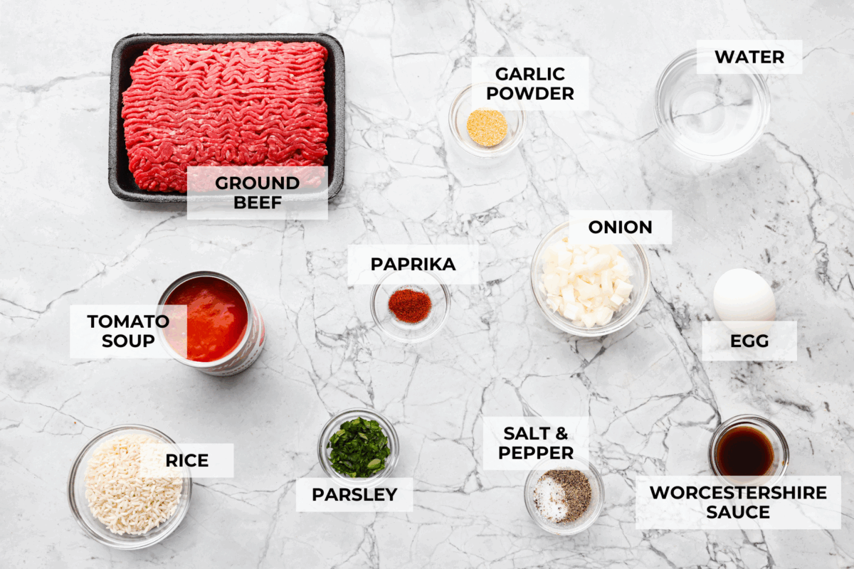 Porcupine Meatballs are juicy, well-seasoned meatballs with tender rice simmered in a rich, tangy tomato sauce. This recipe comes straight from my grandma’s kitchen, and trust me, your family’s about to be obsessed! Overhead shot of labeled ingredients.