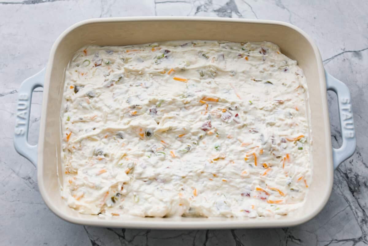If you love jalapeño poppers, you need this dip. It’s creamy, cheesy, loaded with bacon, and topped with buttery Ritz crackers. Best of all, it takes just 10 minutes to prep, and is perfect for game day! Dip ingredients mixed together and spread in a baking dish.