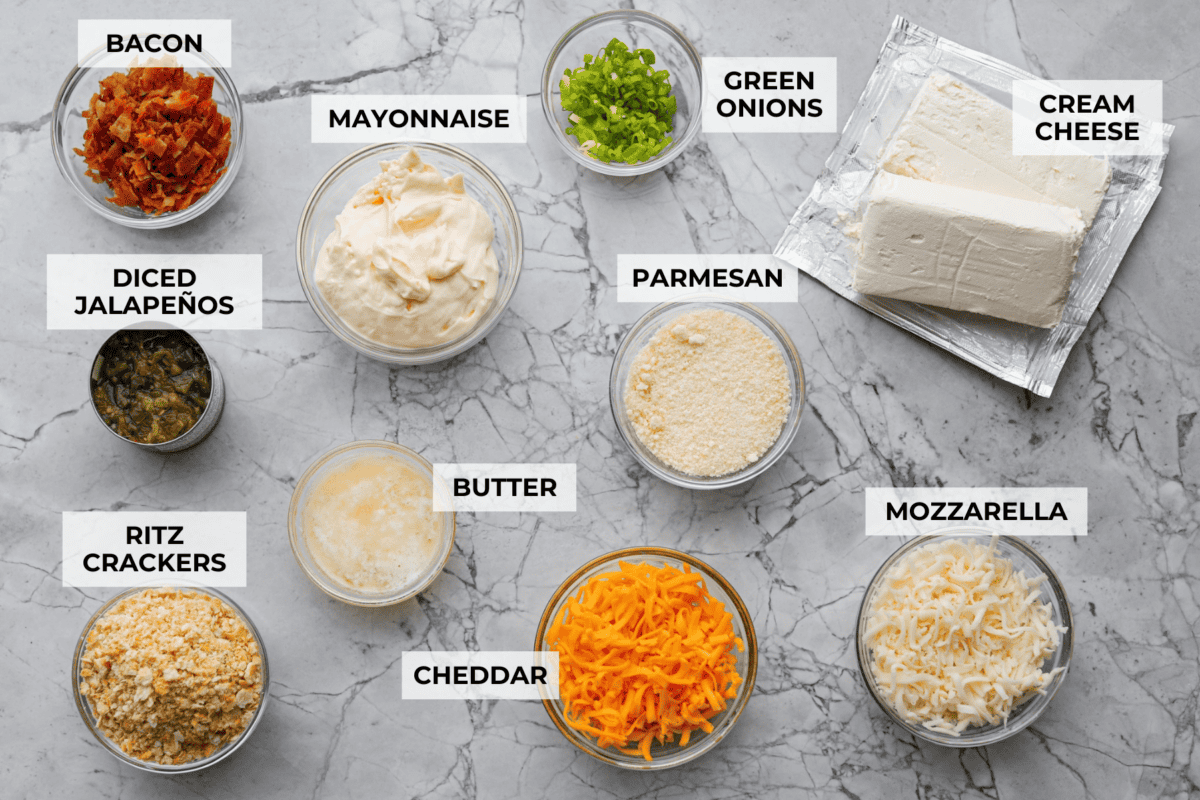 If you love jalapeño poppers, you need this dip. It’s creamy, cheesy, loaded with bacon, and topped with buttery Ritz crackers. Best of all, it takes just 10 minutes to prep, and is perfect for game day! Overhead shot of labeled jalapeño popper dip ingredients.