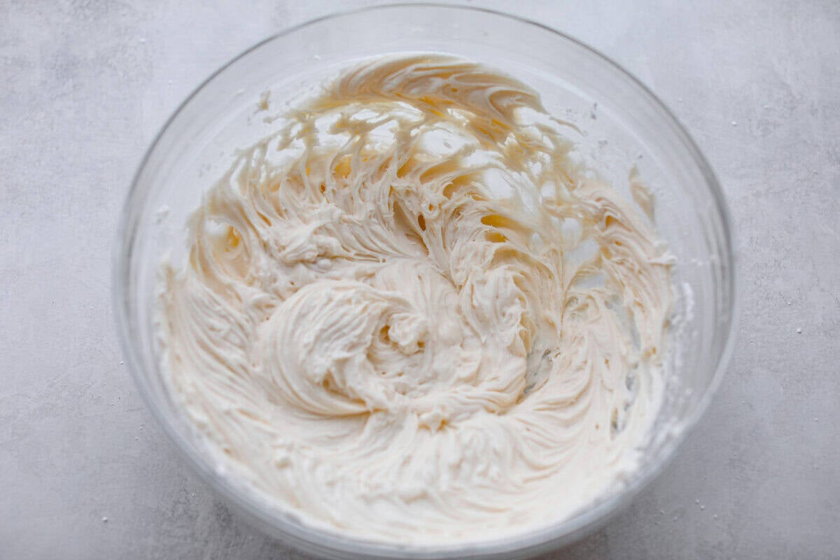 Pumpkin Sheet Cake Bars are one of my oldest son’s favorite desserts, and honestly, I get it! They’re incredibly moist and fluffy, full of warm pumpkin spice, and topped with the best cream cheese frosting. Cream cheese frosting all mixed together ready to be spread on the cake.