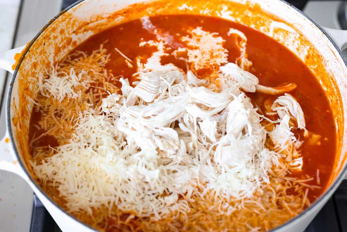 Craving chicken parm? Grab a spoon! This chicken parmesan soup is loaded with tender chicken, pasta, and a rich, creamy tomato broth. Finish with crispy, buttery breadcrumbs for a delicious twist on the Italian classic! Shredded chicken, heavy cream, and Parmesan cheese added to the pot.