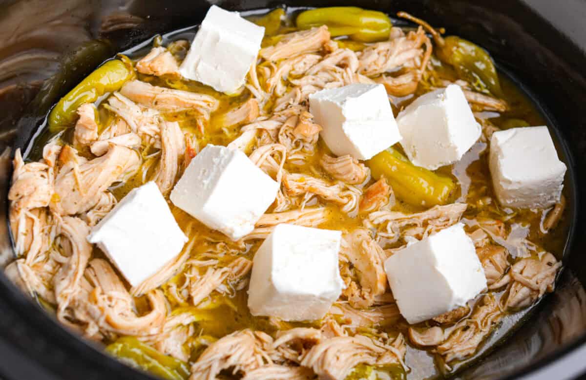 This Mississippi chicken spaghetti gives classic Mississippi chicken a cheesy pasta upgrade! Tender chicken, tangy pepperoncini peppers, ranch, and melty Colby Jack come together with spaghetti for an easy slow cooker dinner packed with flavor. Cream Cheese added to the top of the shredded cooked chicken.