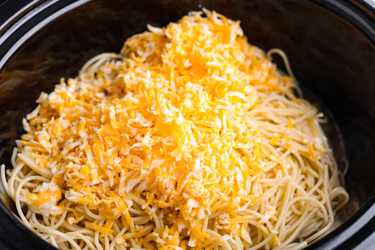 This Mississippi chicken spaghetti gives classic Mississippi chicken a cheesy pasta upgrade! Tender chicken, tangy pepperoncini peppers, ranch, and melty Colby Jack come together with spaghetti for an easy slow cooker dinner packed with flavor. Cooked pasta and cheese added to the slow cooker.