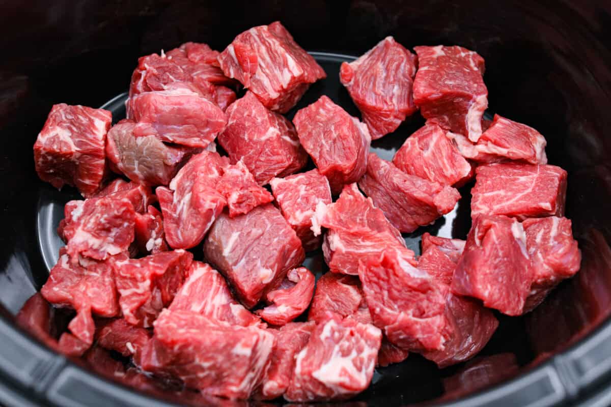 I love a good takeout-inspired dinner, especially when my slow cooker does most of the work! My slow cooker sesame ginger beef is packed with sweet and savory flavor, and the chuck roast cooks until it's perfectly tender. Beef cut into chunks and placed in the slow cooker.