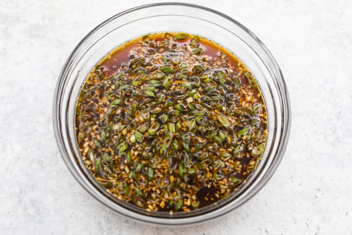 I love a good takeout-inspired dinner, especially when my slow cooker does most of the work! My slow cooker sesame ginger beef is packed with sweet and savory flavor, and the chuck roast cooks until it's perfectly tender. Bowl full of sauce ingredients combined.