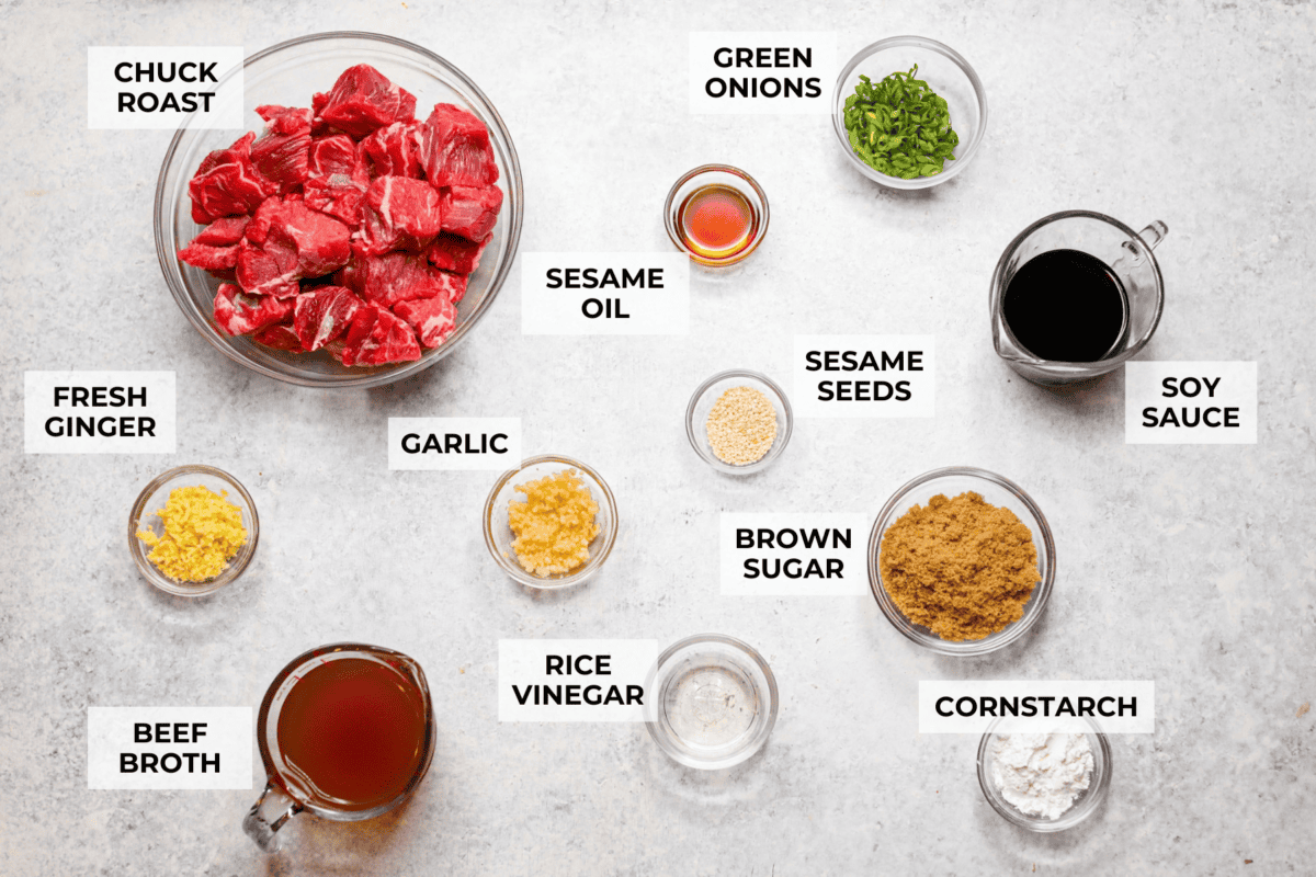 I love a good takeout-inspired dinner, especially when my slow cooker does most of the work! My slow cooker sesame ginger beef is packed with sweet and savory flavor, and the chuck roast cooks until it's perfectly tender. Overhead shot of labeled slow cooker sesame ginger beef ingredients.