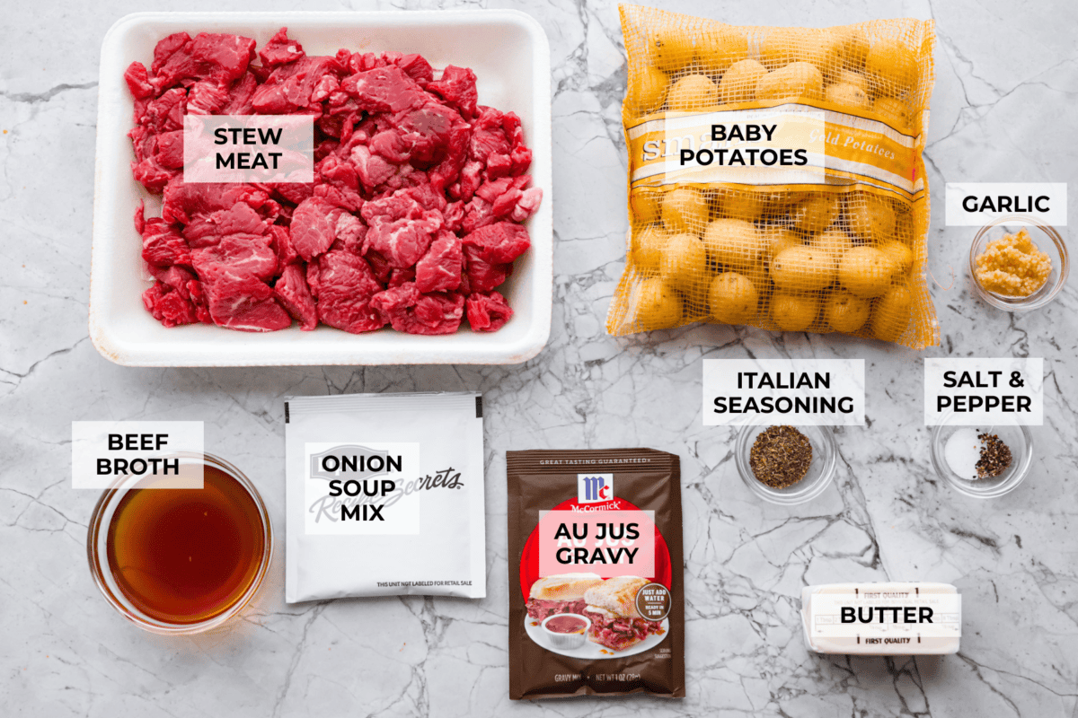 Overhead shot of labeled slow cooker steak and potatoes ingredients. 